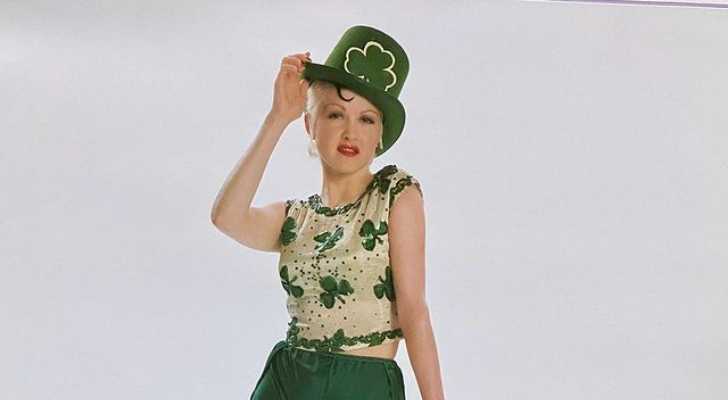 Picture of Cyndi Lauper celebrating St. Patrick Day waring St. Patrick Day clothe and posing for a photo.